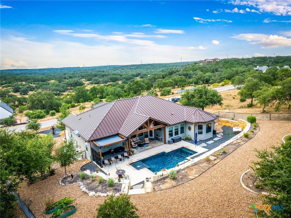 5943 Colin Ridge New Braunfels, TX 78132 - Photo 8 of 37 a view of a patio with table and chairs under an umbrella