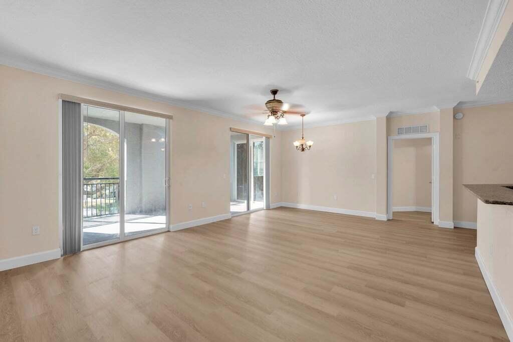 1690 Renaissance Commons Boulevard, Unit 1219 Boynton Beach, FL 33426 - Photo 11 of 38 a view of an empty room with wooden floor and a window