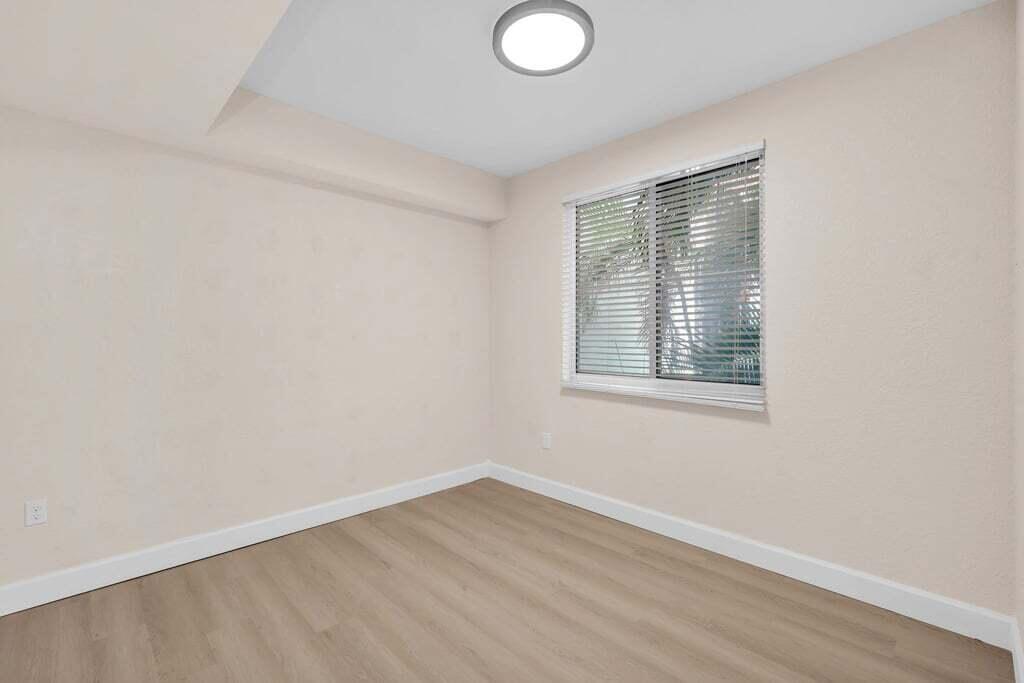 1690 Renaissance Commons Boulevard, Unit 1219 Boynton Beach, FL 33426 - Photo 19 of 38 wooden floor in an empty room
