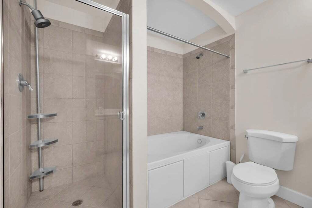 1690 Renaissance Commons Boulevard, Unit 1219 Boynton Beach, FL 33426 - Photo 29 of 38 a bathroom with a toilet and shower