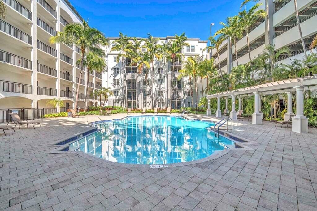 1690 Renaissance Commons Boulevard, Unit 1219 Boynton Beach, FL 33426 - Photo 34 of 38 a view of outdoor space swimming pool and furniture