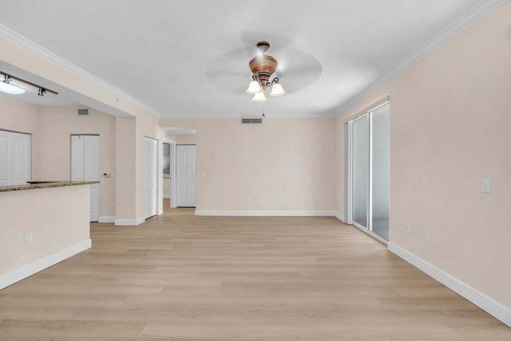 1690 Renaissance Commons Boulevard, Unit 1219 Boynton Beach, FL 33426 - Photo 5 of 38 a view of an empty room with a kitchen