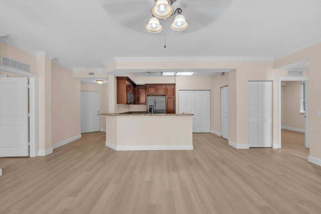 1690 Renaissance Commons Boulevard, Unit 1219 Boynton Beach, FL 33426 - Photo 10 of 38 a view of kitchen with granite countertop cabinets and refrigerator