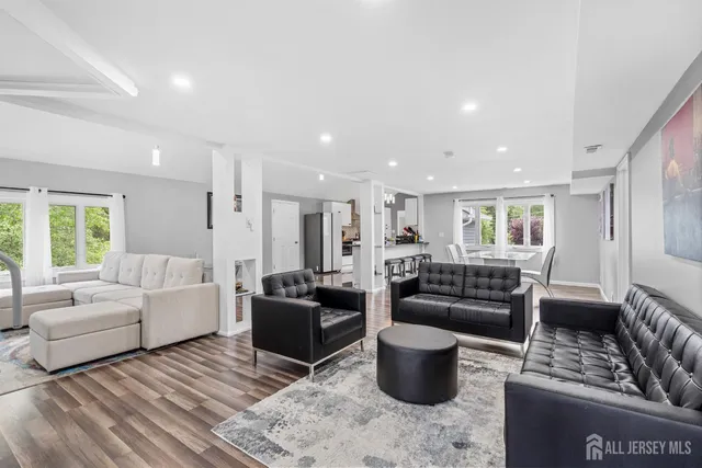 a living room with furniture a rug and a window
