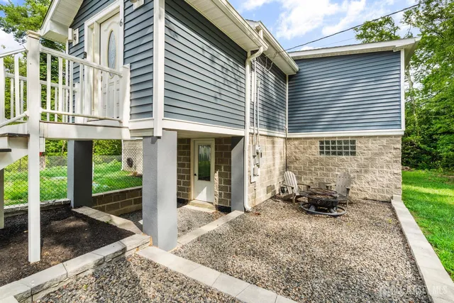 a view of a brick house with large windows and a table