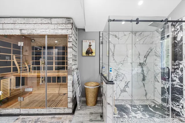 a bathroom with a granite countertop shower and a sink