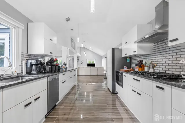 a large white kitchen with lots of counter space