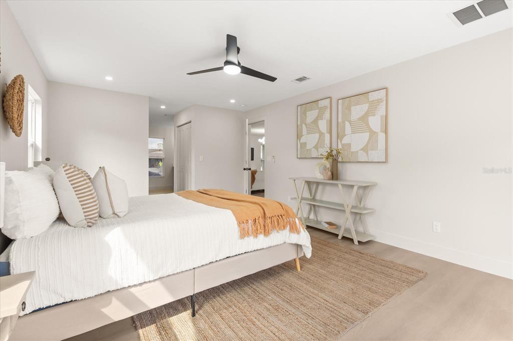 206 Graham Road Fern Park, FL 32730 - Photo 13 of 34 a bedroom with a large bed and a chandelier