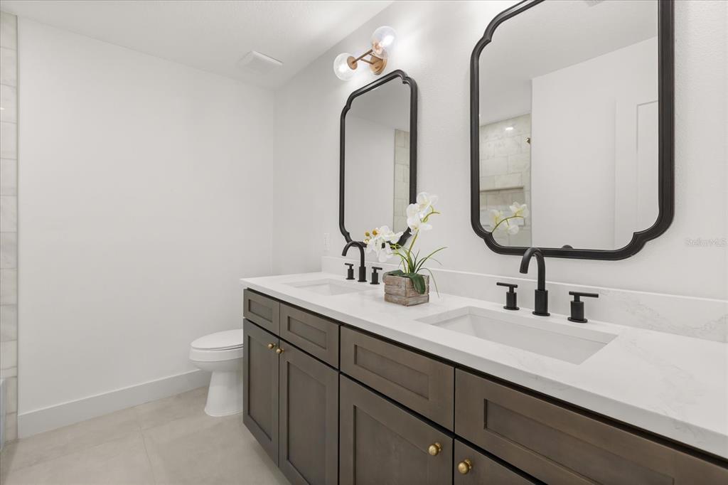 206 Graham Road Fern Park, FL 32730 - Photo 18 of 34 a bathroom with a double vanity sink and a mirror