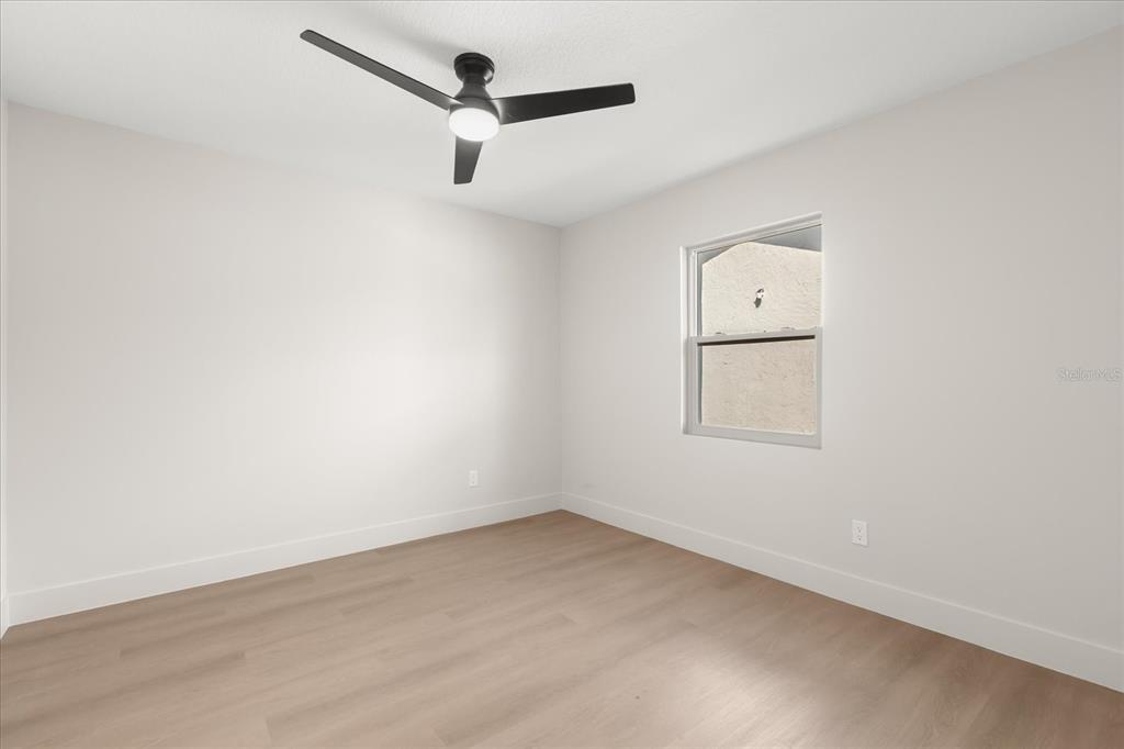 206 Graham Road Fern Park, FL 32730 - Photo 25 of 34 an empty room with a window and a ceiling fan