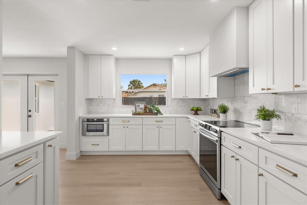 206 Graham Road Fern Park, FL 32730 - Photo 5 of 34 a kitchen with white cabinets and appliances