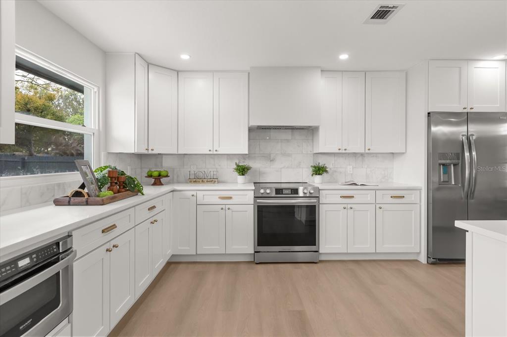 206 Graham Road Fern Park, FL 32730 - Photo 6 of 34 a kitchen with stainless steel appliances granite countertop a refrigerator sink and stove