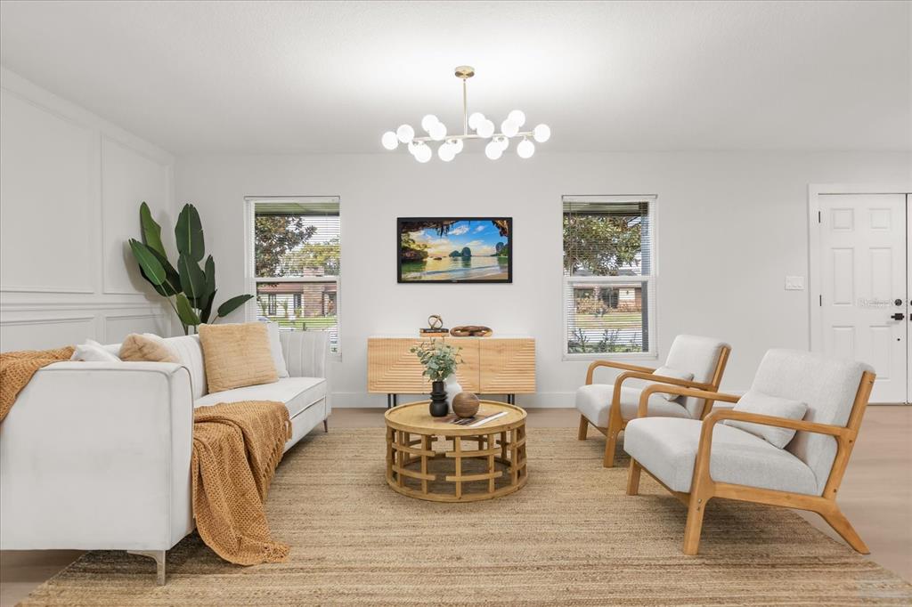 206 Graham Road Fern Park, FL 32730 - Photo 9 of 34 a living room with furniture a chandelier and a flat screen tv