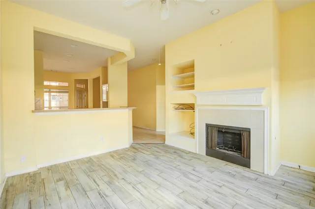 a view of a room with wooden floor and a fireplace