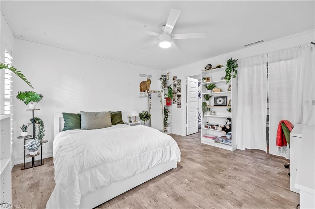 3231 13th Avenue Southwest Naples, FL 34117 - Photo 15 of 49 a bedroom with a bed and a couch
