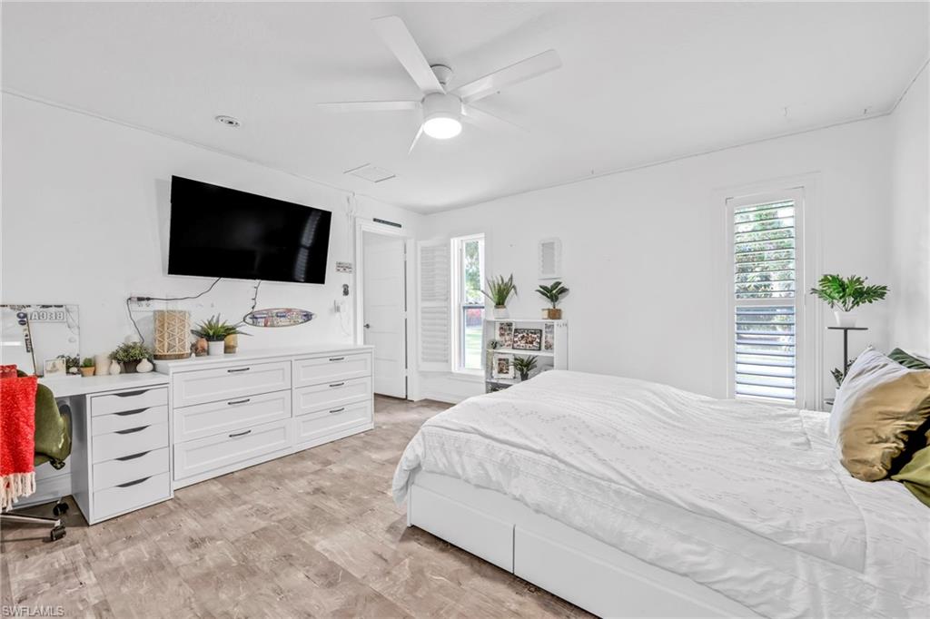 3231 13th Avenue Southwest Naples, FL 34117 - Photo 16 of 49 a bedroom with a bed and a flat screen tv