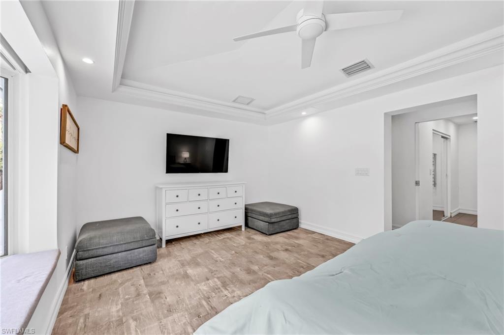 3231 13th Avenue Southwest Naples, FL 34117 - Photo 20 of 49 a bedroom with a bed and flat screen tv