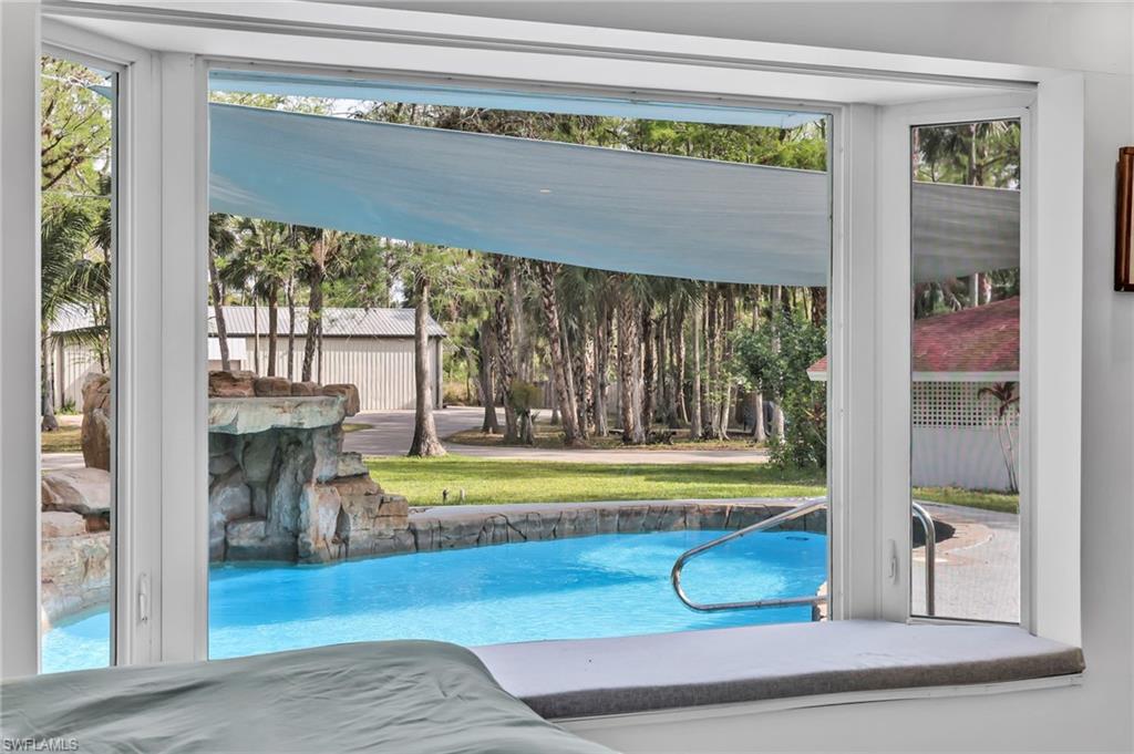 3231 13th Avenue Southwest Naples, FL 34117 - Photo 21 of 49 a view of swimming pool with a table and chairs
