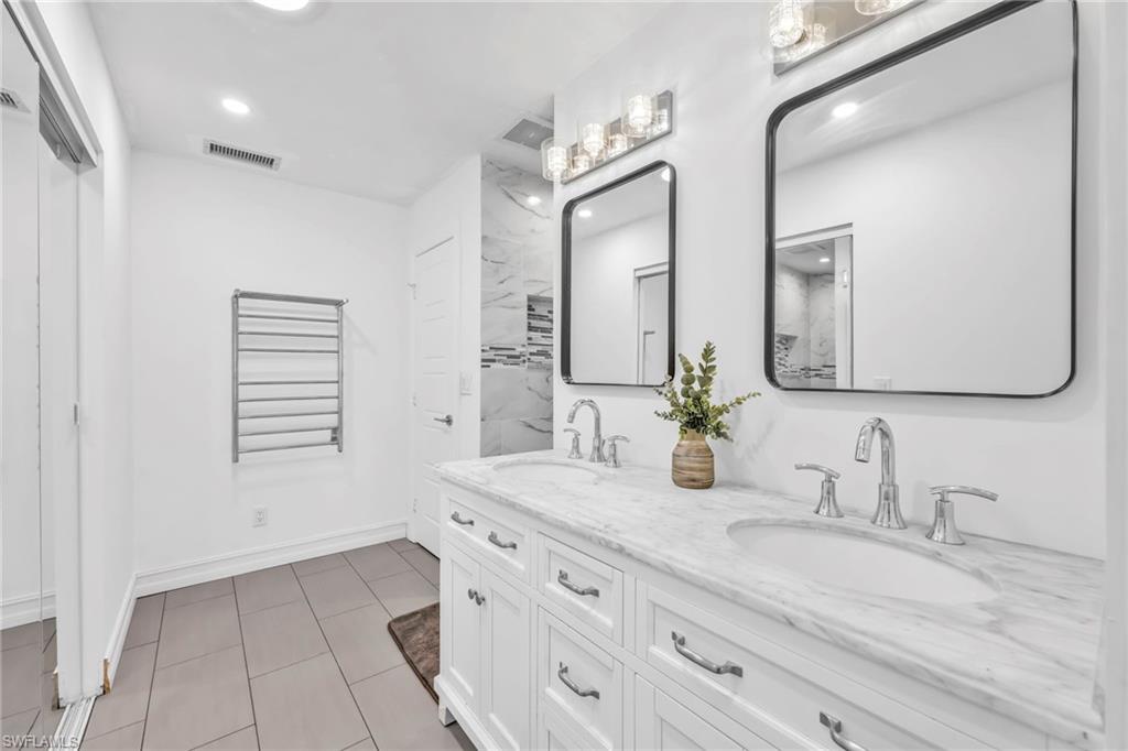 3231 13th Avenue Southwest Naples, FL 34117 - Photo 22 of 49 a bathroom with a double vanity sink and a mirror