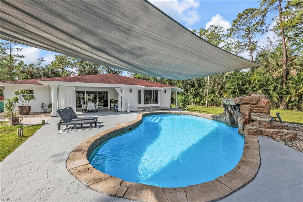 3231 13th Avenue Southwest Naples, FL 34117 - Photo 24 of 49 swimming pool view with a seating space