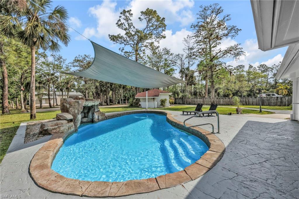 3231 13th Avenue Southwest Naples, FL 34117 - Photo 26 of 49 a swimming pool with outdoor seating and yard