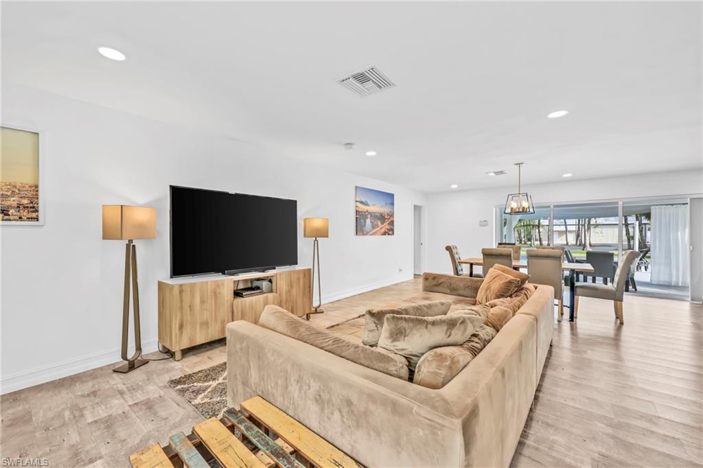 3231 13th Avenue Southwest Naples, FL 34117 - Photo 3 of 49 a living room with furniture and a flat screen tv