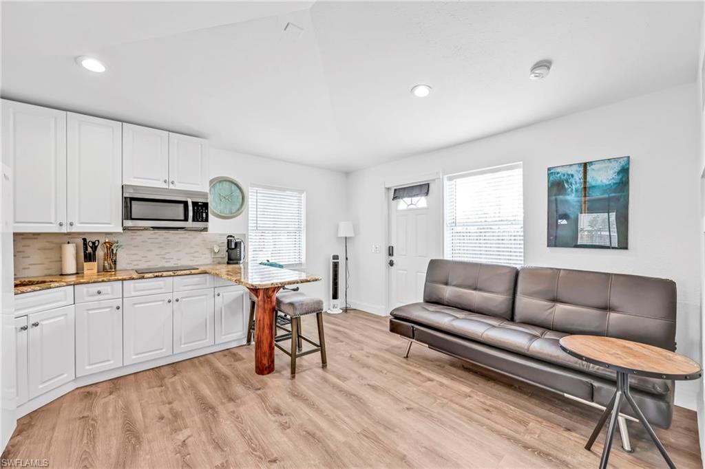 3231 13th Avenue Southwest Naples, FL 34117 - Photo 31 of 49 a living room with furniture and a wooden floor