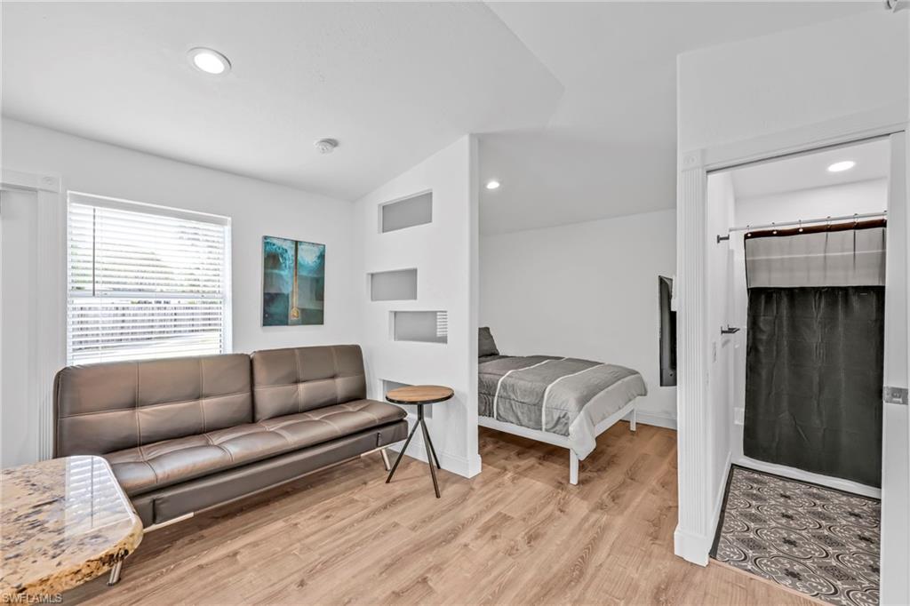 3231 13th Avenue Southwest Naples, FL 34117 - Photo 33 of 49 a living room with furniture and a rug