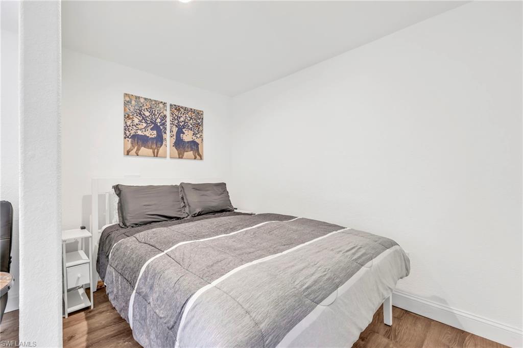 3231 13th Avenue Southwest Naples, FL 34117 - Photo 34 of 49 a bedroom with a bed and a wall painting