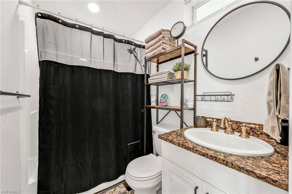 3231 13th Avenue Southwest Naples, FL 34117 - Photo 36 of 49 a bathroom with a sink a toilet and a mirror