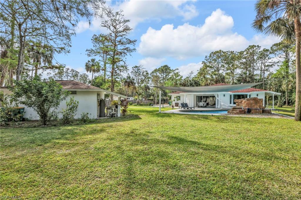3231 13th Avenue Southwest Naples, FL 34117 - Photo 38 of 49 a front view of a house with a garden