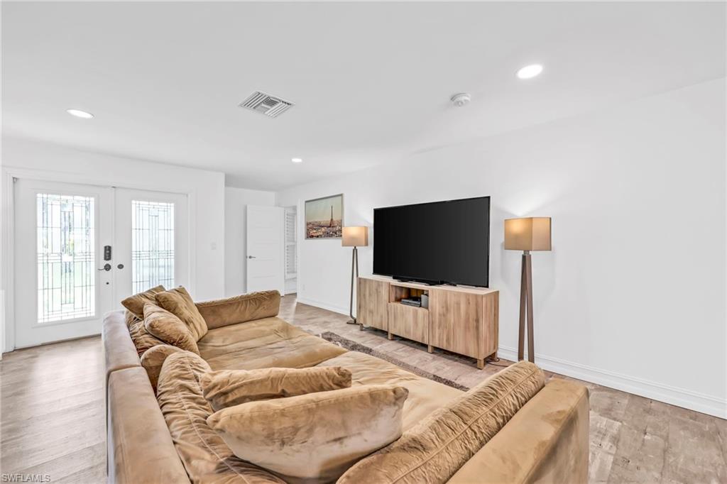 3231 13th Avenue Southwest Naples, FL 34117 - Photo 4 of 49 a living room with furniture and a flat screen tv