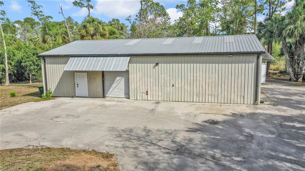 3231 13th Avenue Southwest Naples, FL 34117 - Photo 43 of 49 a front view of a house with a garage