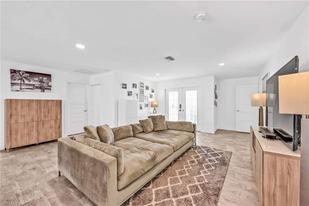 3231 13th Avenue Southwest Naples, FL 34117 - Photo 5 of 49 a living room with furniture a flat screen tv and a couch