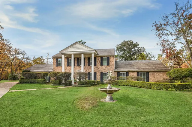 a front view of a house with a yard table and chairs