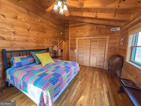 a bedroom with a large bed and a chandelier
