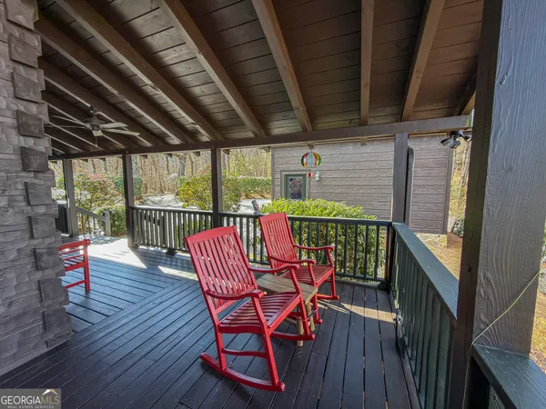 a outdoor living space with patio furniture and wooden floor