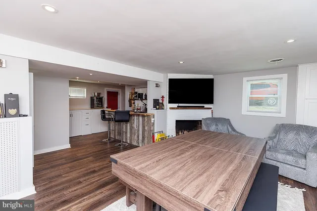 a living room with a flat screen tv and a fireplace