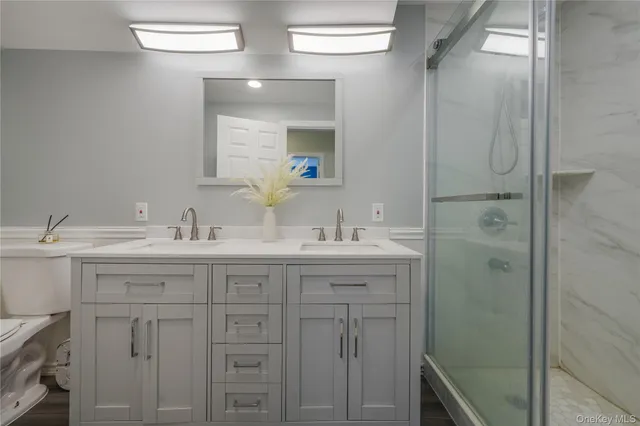 a bathroom with a double vanity sink and mirror