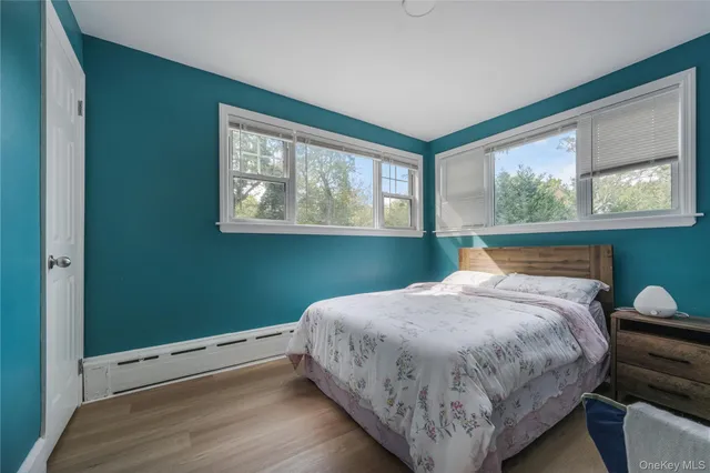 a bed sitting in a bedroom next to a window