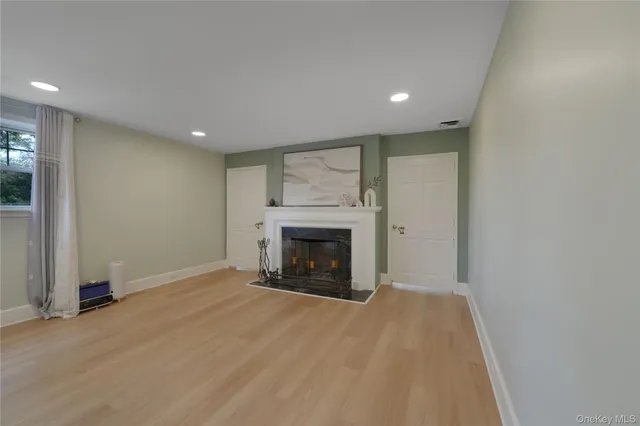 a view of an empty room with a fireplace