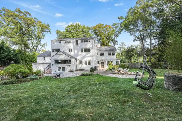 a view of a house with backyard porch and sitting area