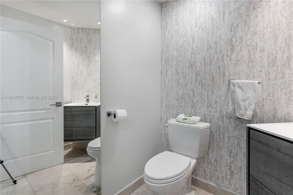 a white toilet sitting next to a shower curtain