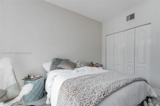 a bedroom with a bed and a closet