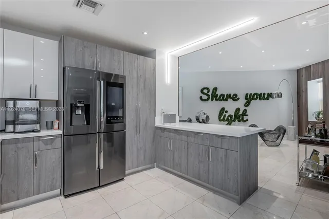 a kitchen with stainless steel appliances a refrigerator and a sink