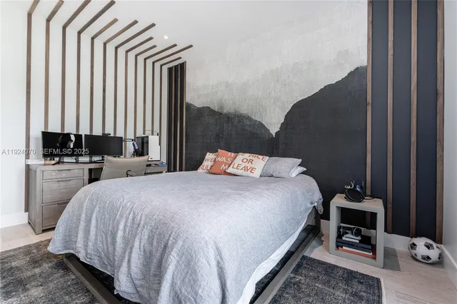 a bed sitting in a bedroom next to a window