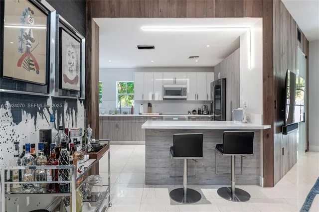 a kitchen with stainless steel appliances kitchen island granite countertop a sink and cabinets