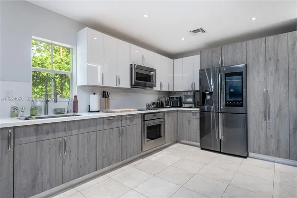 a kitchen with a refrigerator sink and microwave