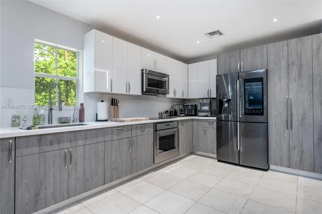 a kitchen with a refrigerator sink and microwave