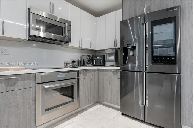 a kitchen with stainless steel appliances granite countertop a refrigerator and a microwave
